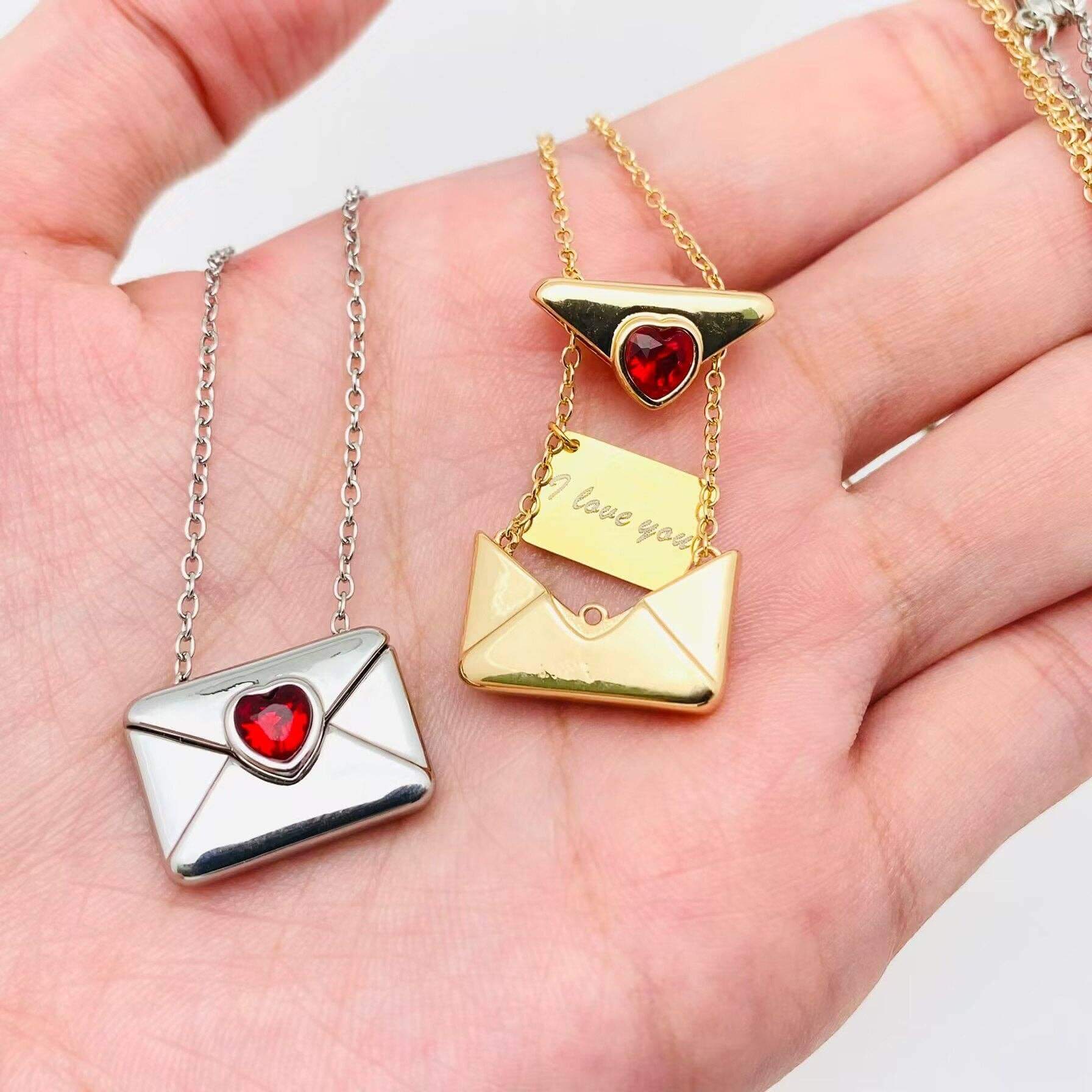 LOVE LETTER NECKLACE featuring elegant envelope pendants with red heart accents, perfect for expressing love.