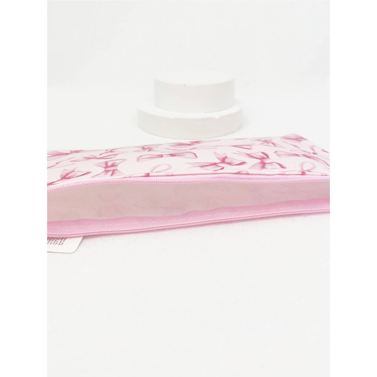 BOW ME OVER COSMETICS BAG in pink design, perfect for organizing everyday makeup essentials and fitting in your purse.