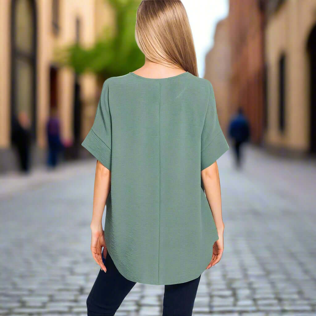 Model wearing the Soft Breeze Top in Ash Jade, showcasing its relaxed fit and stylish design.