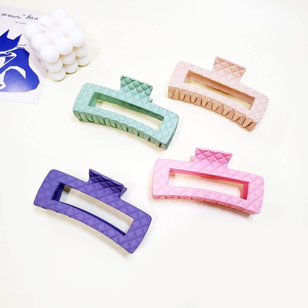 Everyday Luxe XL Hair Clips in four colors - peach, green, pink, and purple with quilted texture for secure hold.