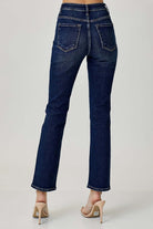 Back view of Risen ADELINE midrise straight jeans in dark wash, styled with high heels.