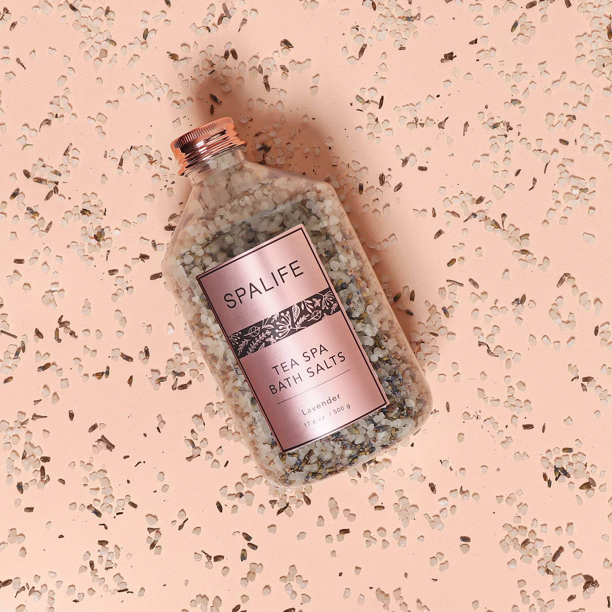 SpaLife Petal-Infused Bath Salts (2 SCENTS) in lavender jar on a pink background, perfect for soothing bath experiences.