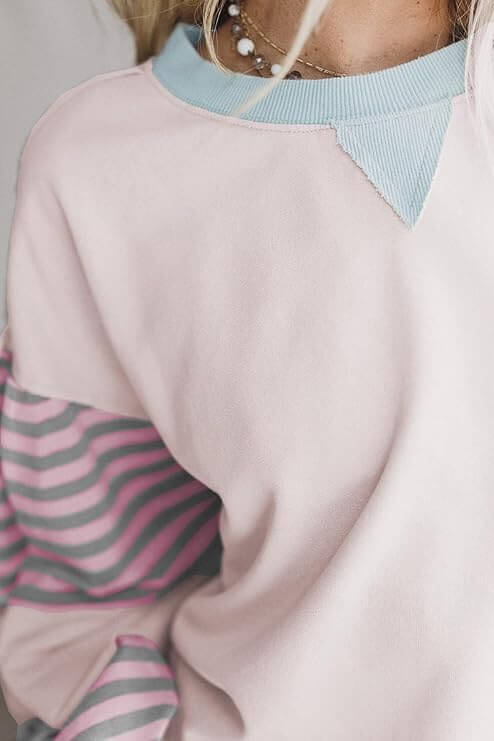 Close-up of the EASYGOING ERA CREW (taffy) showing colorblock design and striped patchwork sleeves for a trendy casual look.