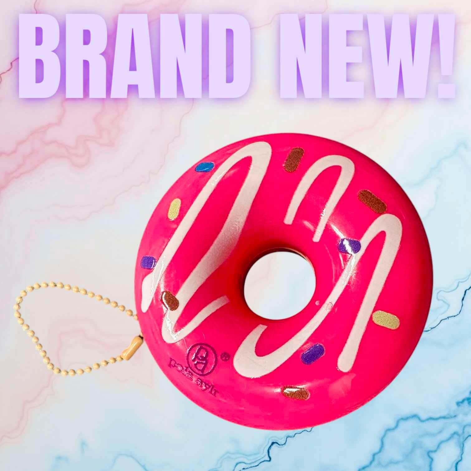 Bright pink donut-shaped lip balm keychain, perfect for on-the-go lip care. New and fun design!