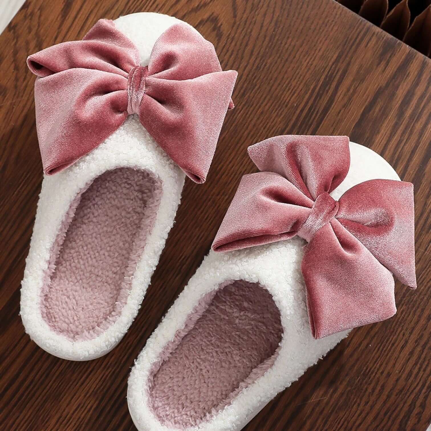 SWEET RETREAT BOW SLIPPERS with oversized velvet bows and soft sherpa exterior, perfect for cozy winter lounging.