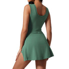 Back view of a jade Power Play Dress by Otos New York, showcasing its sporty and stylish design for active women.