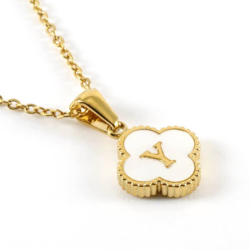 MONOGRAM MOMENTS NECKLACE featuring a gold chain and a luminous white pendant with an elegant initial design.