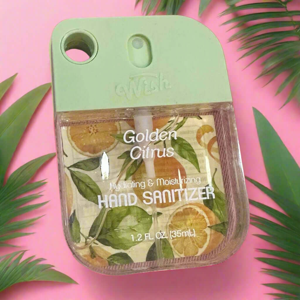 WISH Hand Sanitizer in Golden Citrus scent, 35ml, hydrating formula with a fresh, fruity design on a pink background.