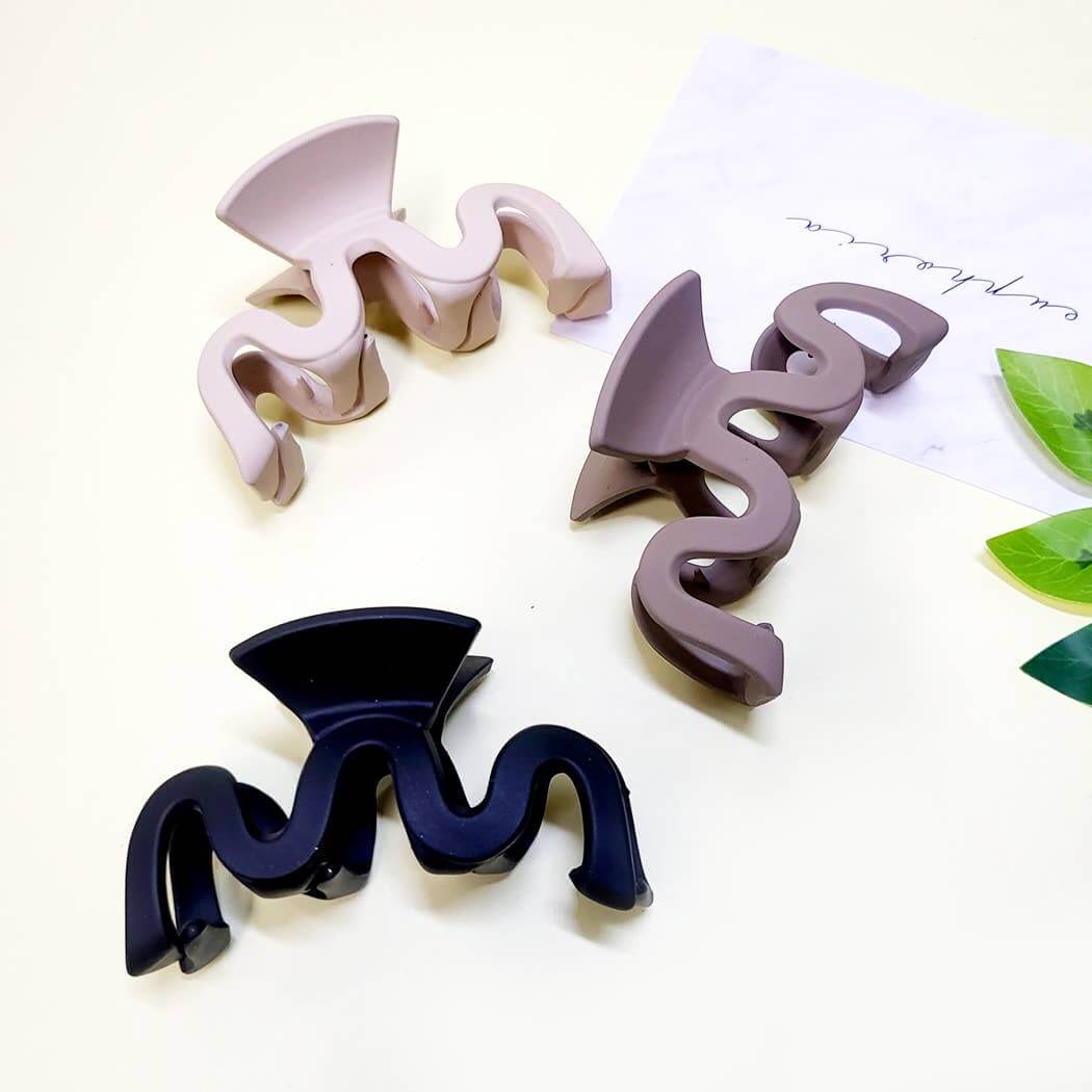 Curve Appeal Hair Clips in three stylish colors: matte wavy claw clips for secure all-day hair styling.
