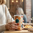 SWIG FALL HARVEST TRAVEL MUG 18 oz. steaming mug on a table with baked goods, perfect for fall adventures.
