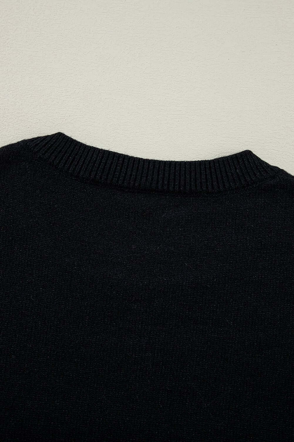 Back view of MERRY & BRIGHT SWEATER by Vivian-Lu, featuring a classic black design and cozy ribbed neckline.