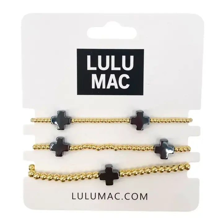 LULU MAC -EBONY GRACE BRACELET SET featuring gold-tone beaded bracelets with cross details.