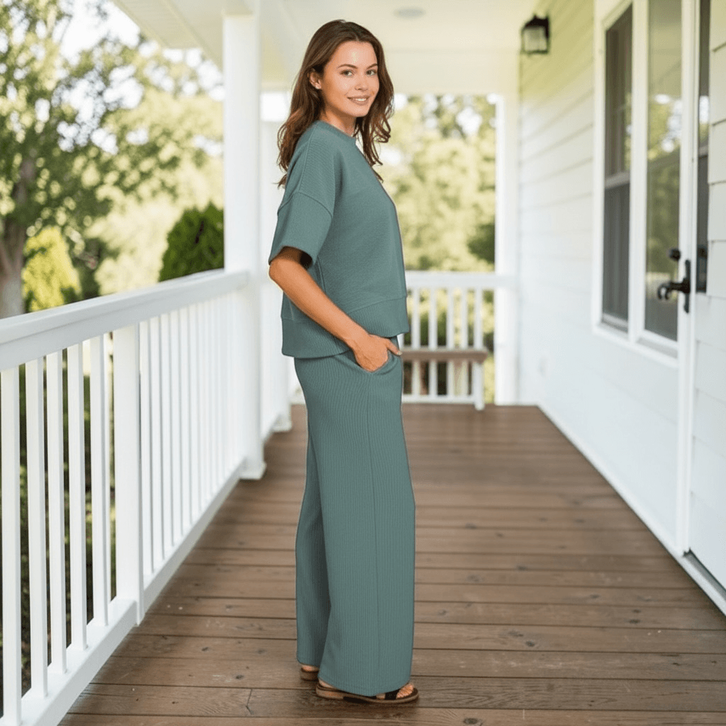 Model showcasing QUIET MOMENTS PANTS SET (ash jade) on a porch, highlighting its stylish and comfortable design.