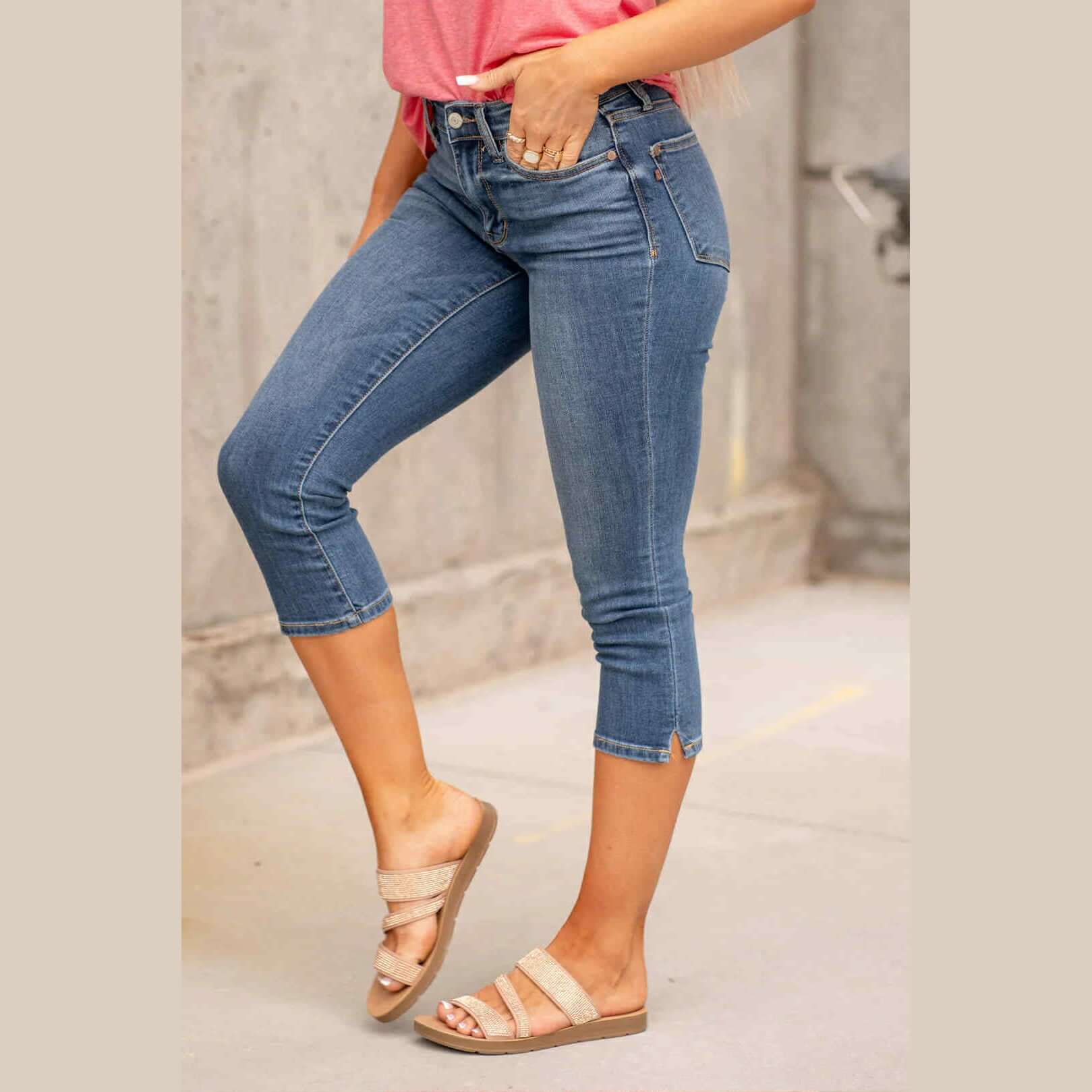 Model wearing Judy Blue Kenzie Mid Rise Capris in medium blue wash, paired with casual sandals.