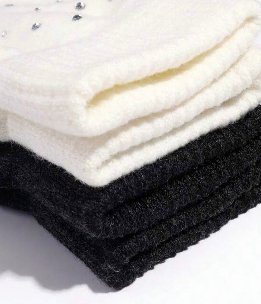 STILL BEJEWELED gloves in winter white and jet black, featuring sparkly rhinestones for warmth and glamour.