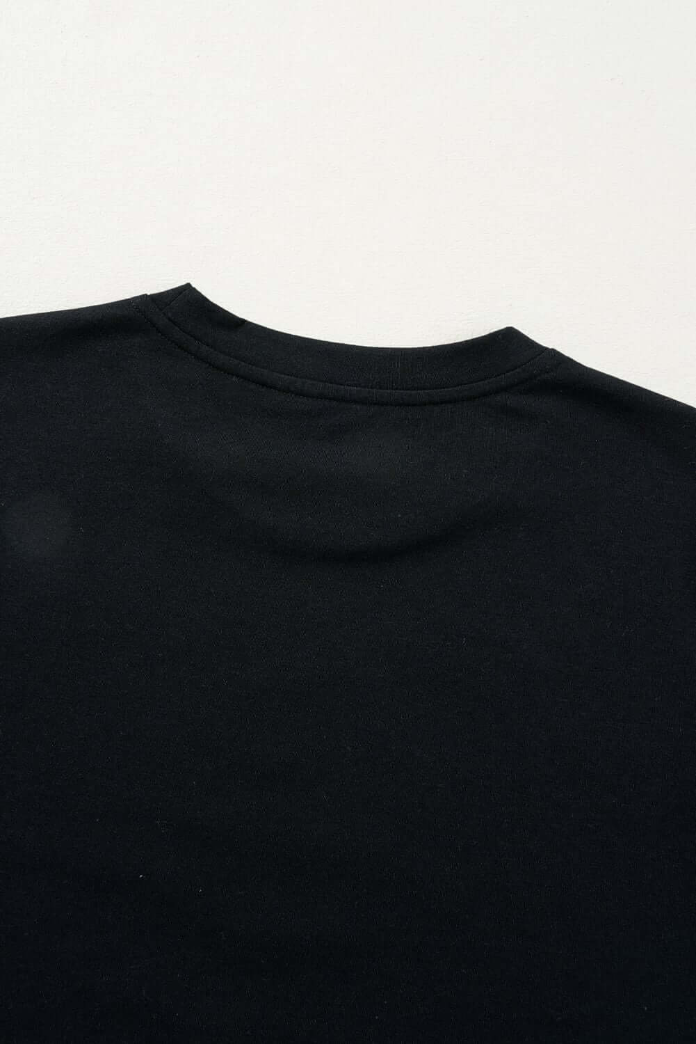 Back view of a lightweight black t-shirt, featuring a classic round neckline and soft fabric.