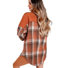 HARVEST HAVEN JACKET featuring a rust colorblock plaid design, flapped pockets, and modern shacket style.