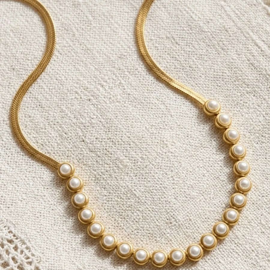 PEARLS OF WISDOM NECKLACE featuring classic pearls and a golden chain, adding elegance to any outfit.