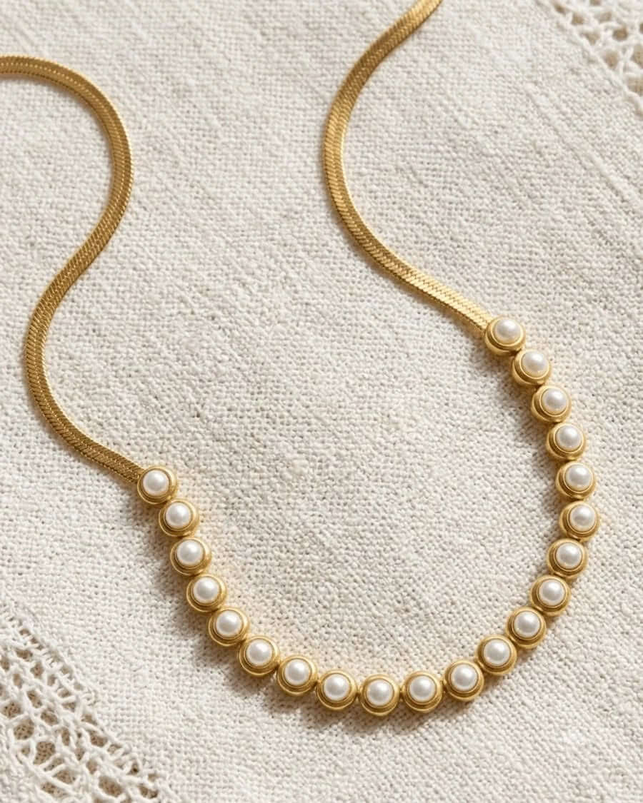 PEARLS OF WISDOM NECKLACE featuring classic pearls and a golden chain, adding elegance to any outfit.