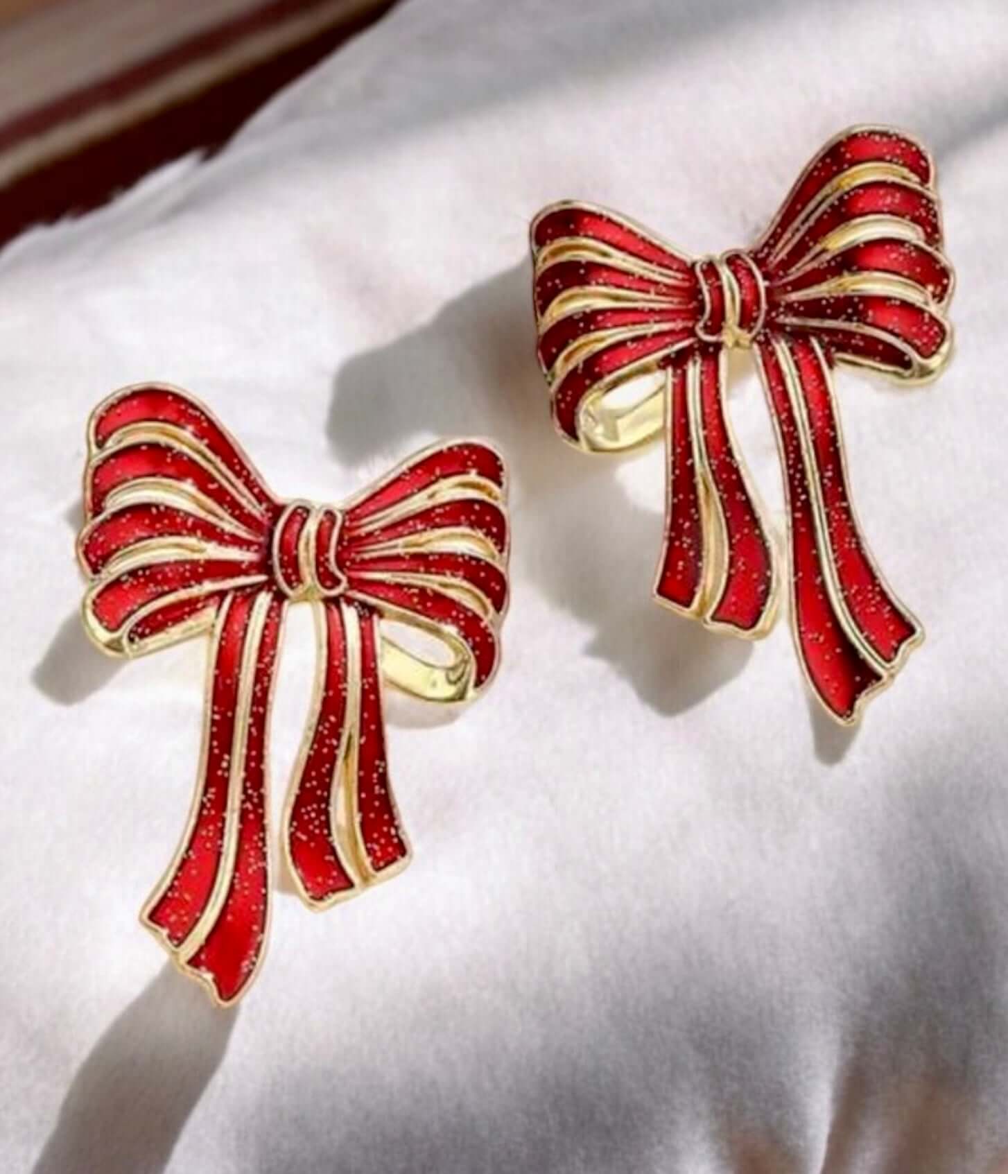 Red and gold bow earrings, 2 inches by 1.4 inches, perfect for adding festive elegance to holiday outfits.