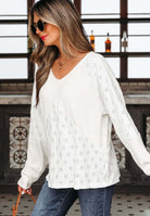 Model wearing the FROSTED FUSION TOP with decorative cutouts, paired with denim and stylish sunglasses.