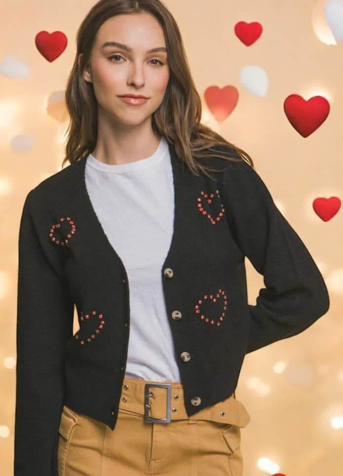 Model wearing Love Tree Give You My Heart Sweater with red rhinestone hearts on a soft background.