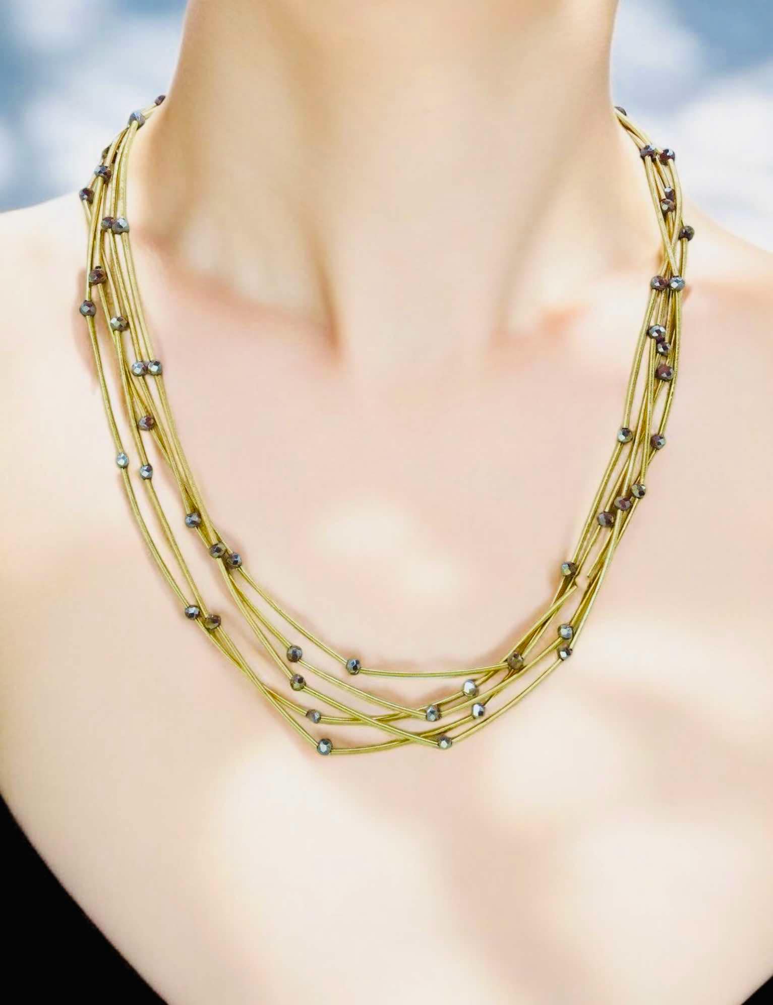 Pretty Strands Necklace by Nine; gold tone multi-strand design with glass beads for a glamorous accessory look.