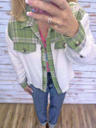 ALPINE CHARM JACKET with green plaid flannel and sherpa design, styled with casual jeans.