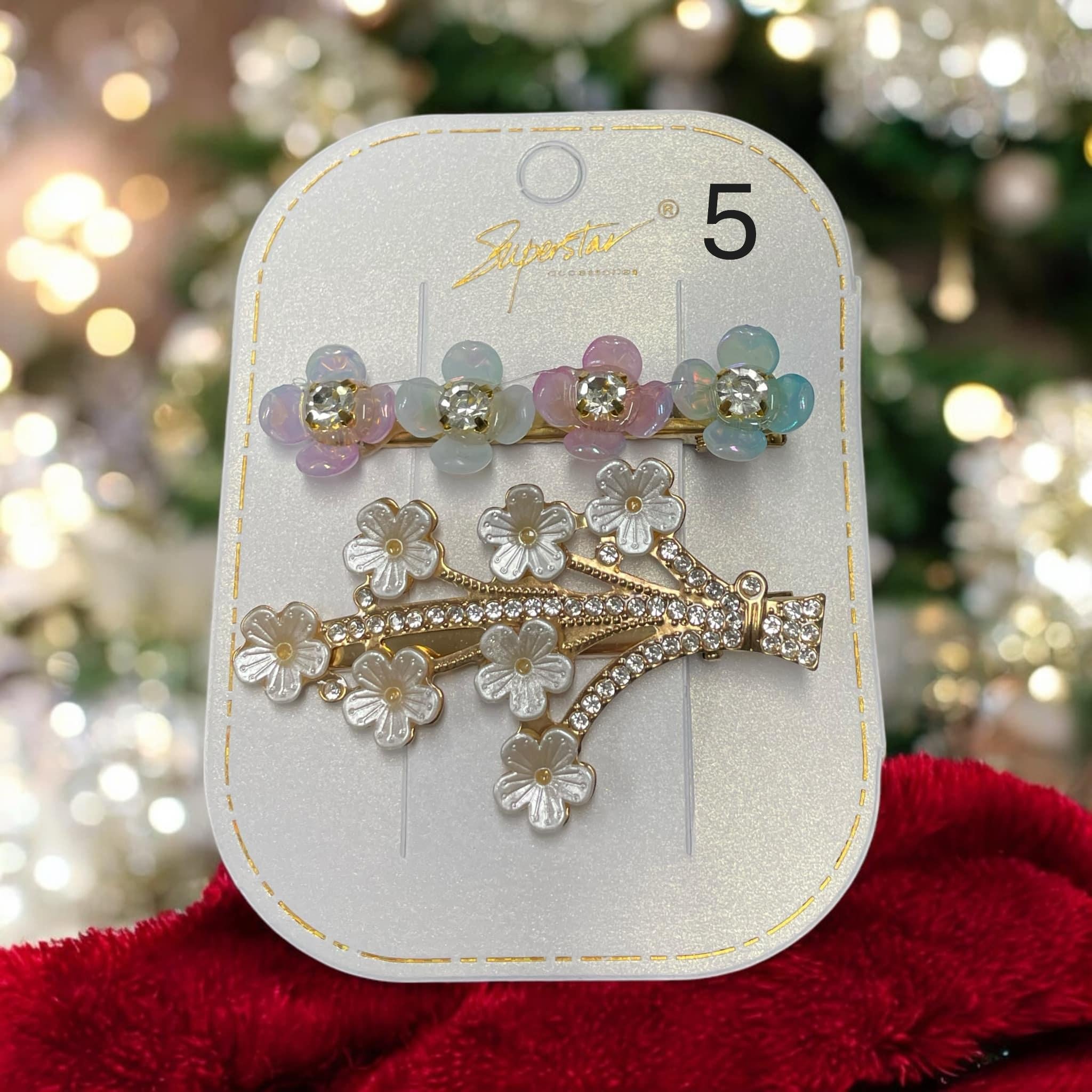 Set of two Superstar Rhinestone and Flower Hair Clips with colorful flower designs, perfect for holiday styling.