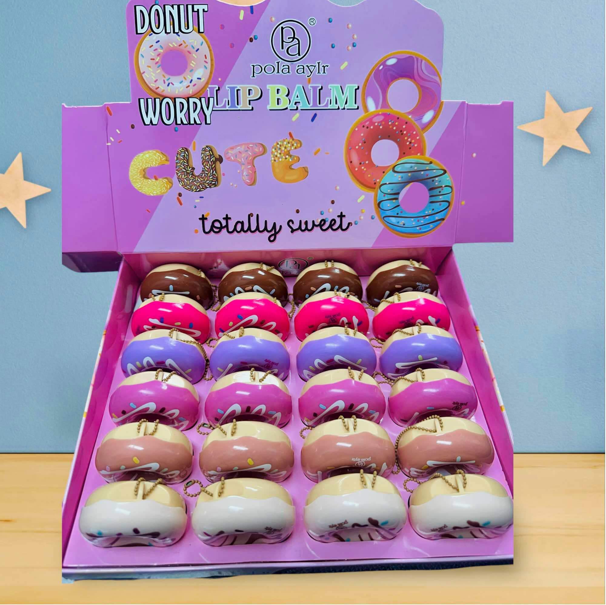 Colorful Donut Worry Lip Balms displayed in a box, perfect for on-the-go lip care and hydration.