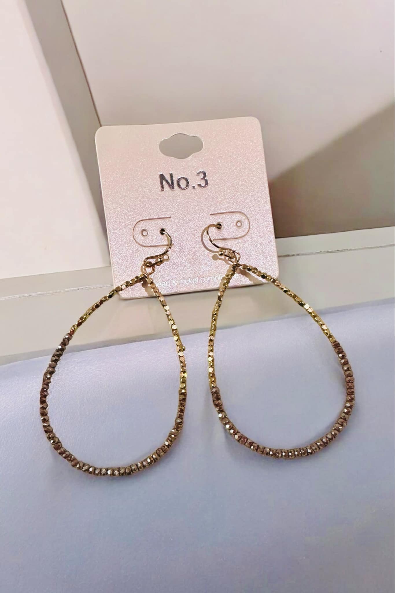 Sharla Beaded Earrings by No. 3 Jewelry, showcasing teardrop design with colorful glass beads and gold accents.