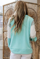 Back view of a woman wearing the AQUA AVENUE TOP with ribbed texture and patchwork design.