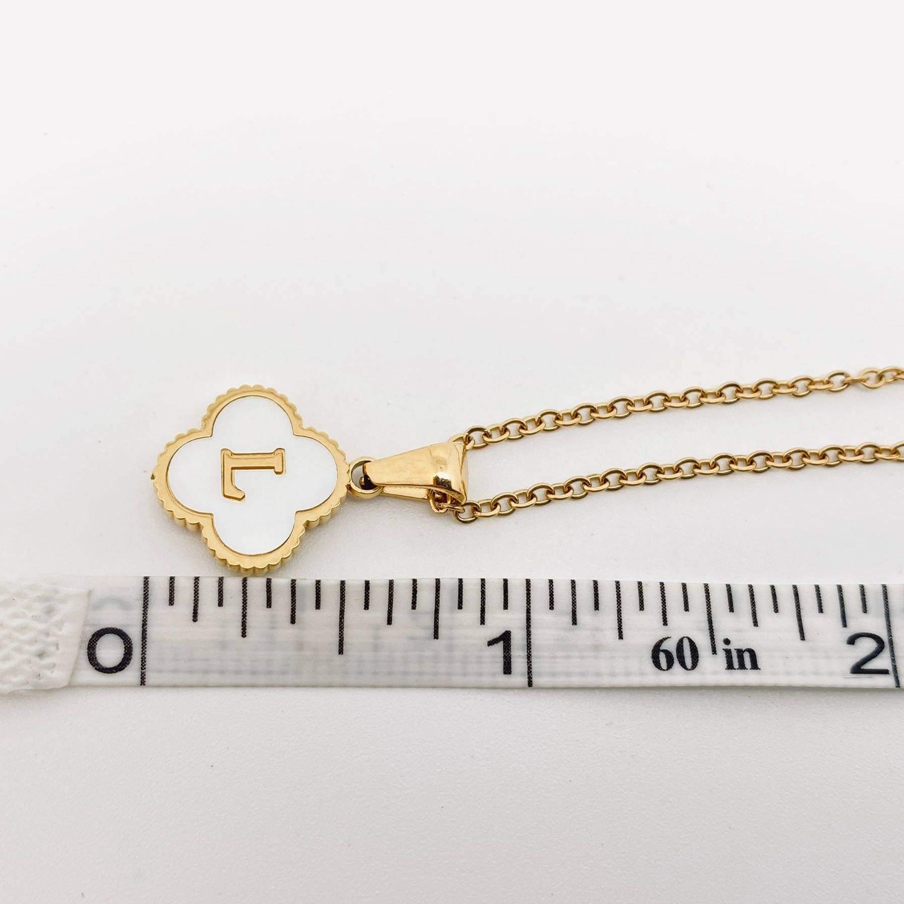 Close-up of MONOGRAM MOMENTS NECKLACE featuring a gold-plated pendant with an initial and delicate chain.