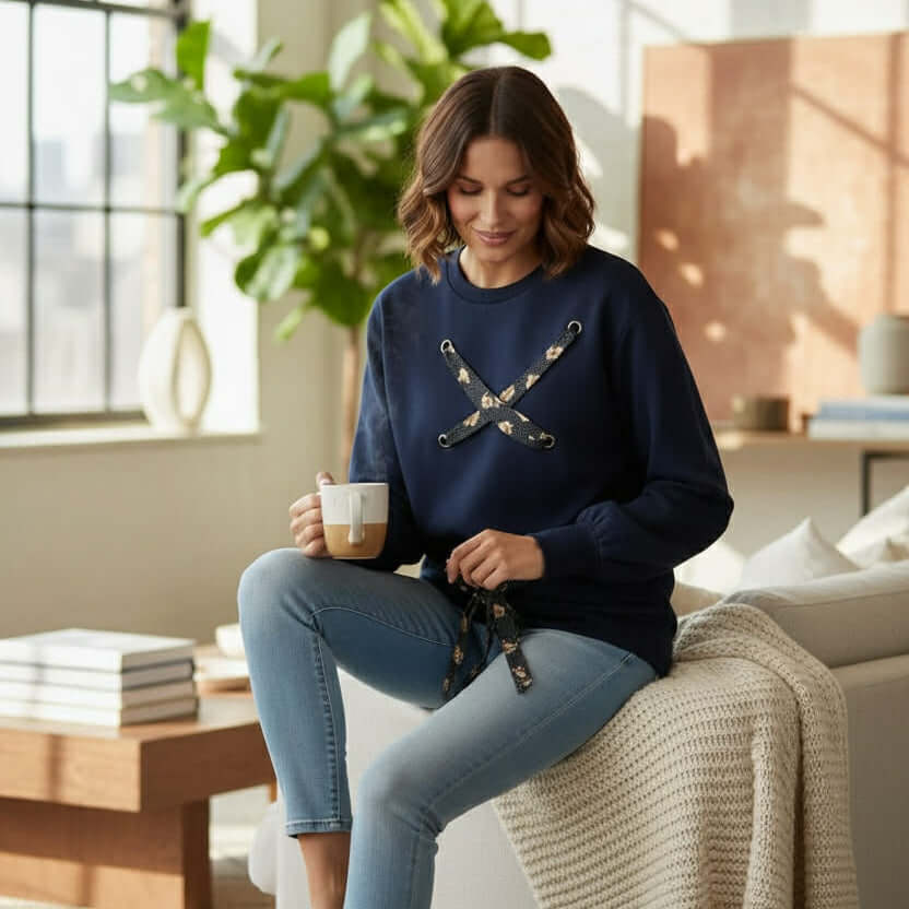 SOFT TIES Crewneck Pullover By Skies Are Blue worn by a woman in a cozy living room with a cup of coffee.