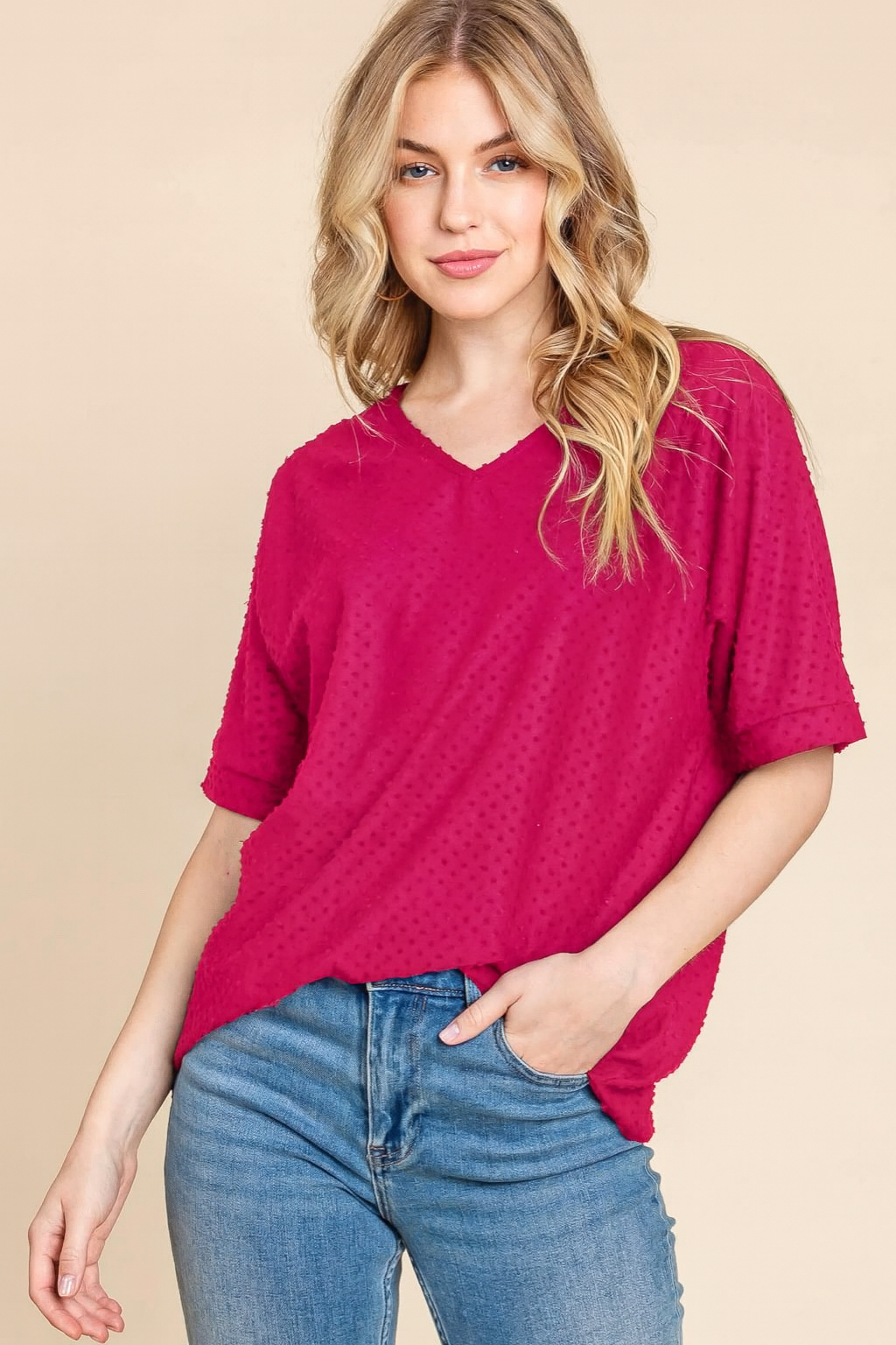 Model wearing the Midnight Moments Top in fuchsia with Swiss dot texture, paired with jeans, exuding effortless style.