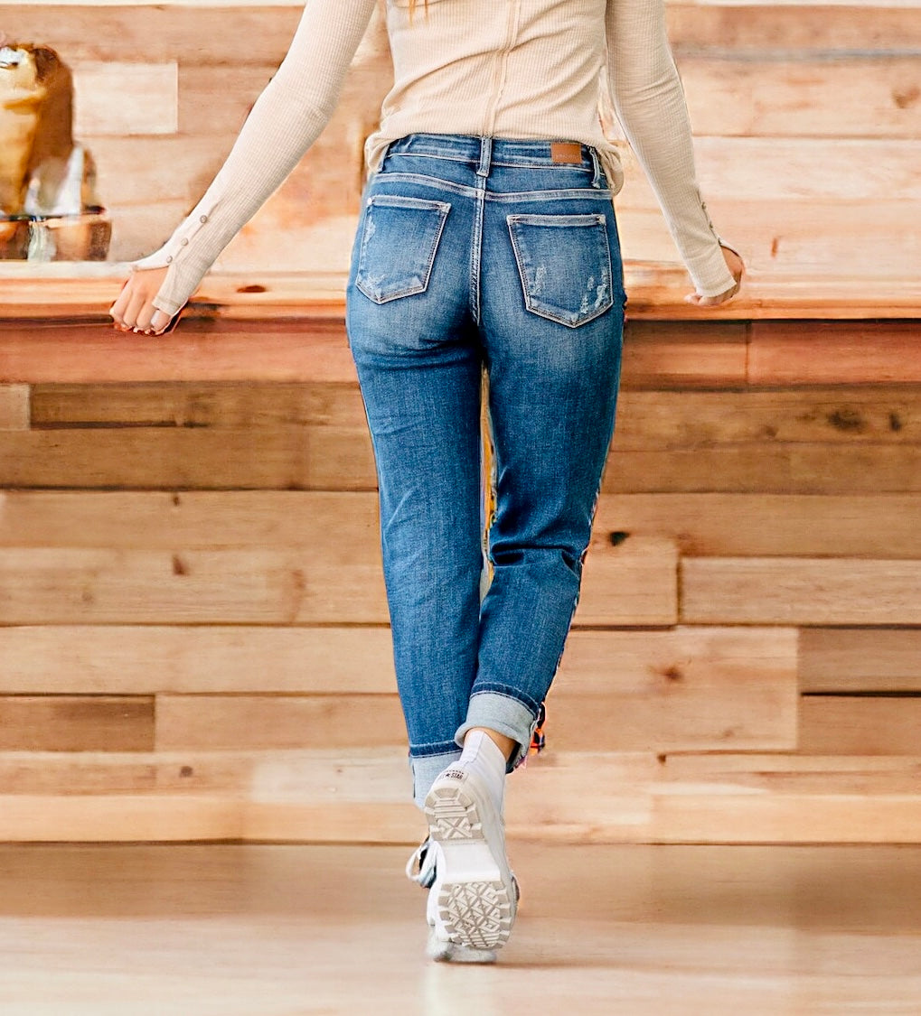 Back view of a woman in dark wash Judy Blue Zoe boyfriend jeans, showcasing mid-rise cuffed fit and stylish design.