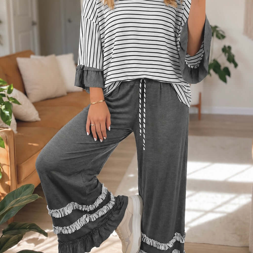 PREORDER - SWEET FLOURISH PANTS SET featuring a stylish gray and white striped top and matching flared pants.