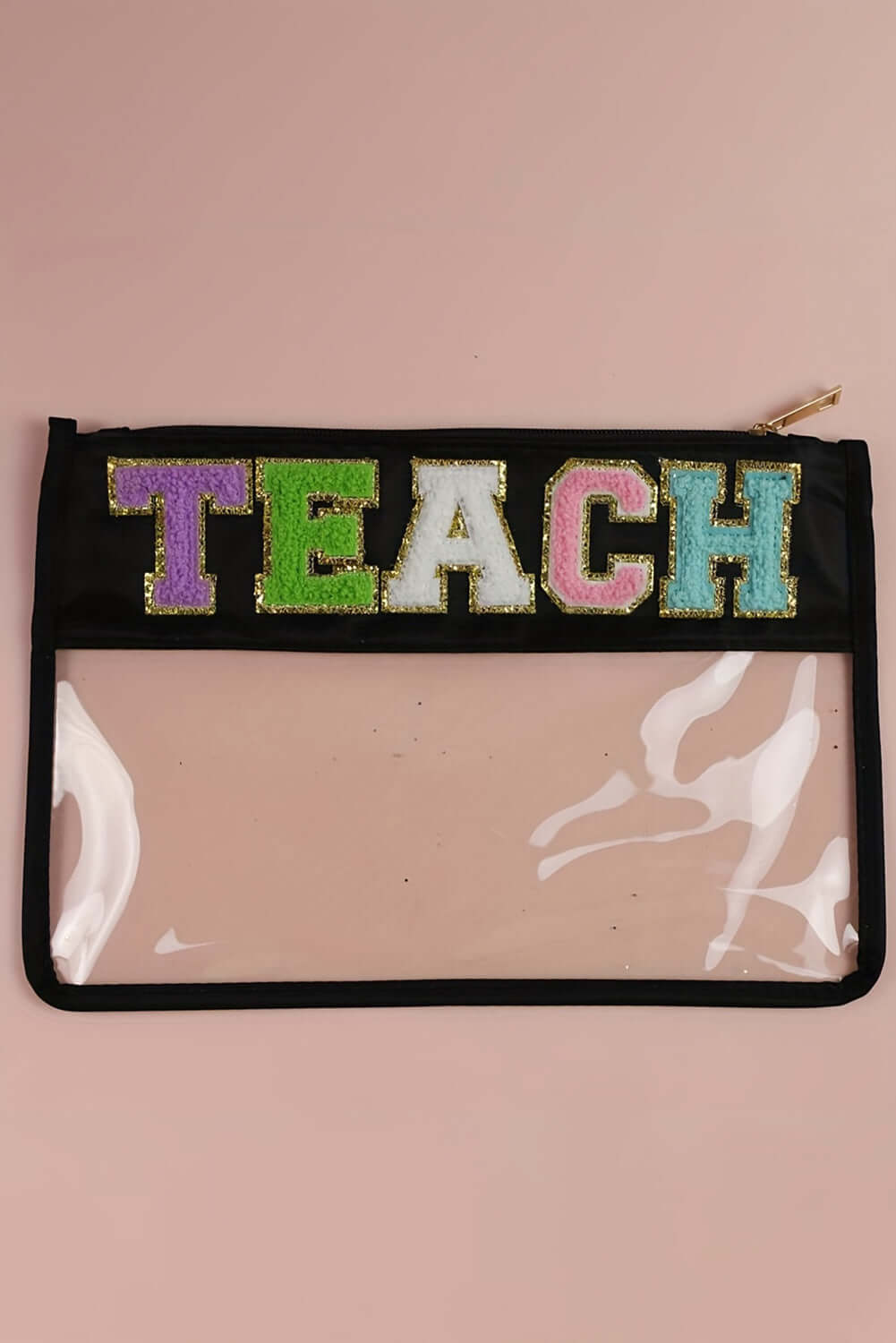 In My Teacher Era clear pouch featuring vibrant glitter 'TEACH' letters on a black background with clear PVC panel.