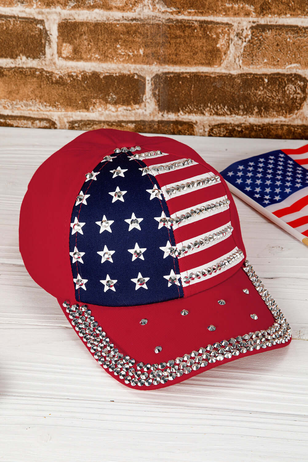 Let Freedom Bling Hat in red with rhinestones, featuring American flag design for a stylish patriotic look.