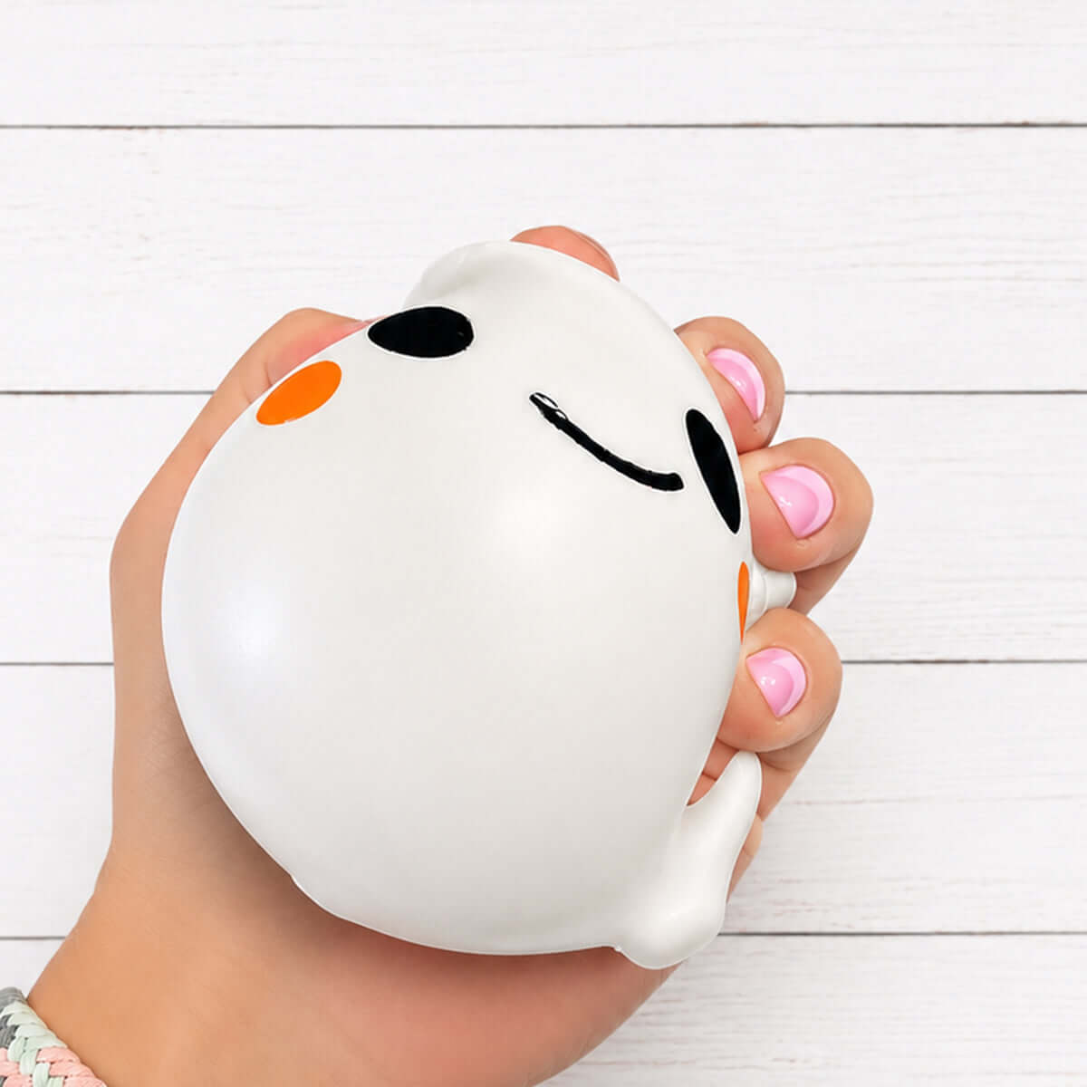 BOO GHOST DUMPLING squishy in a hand with cute face, perfect for sensory play and Halloween decorations.
