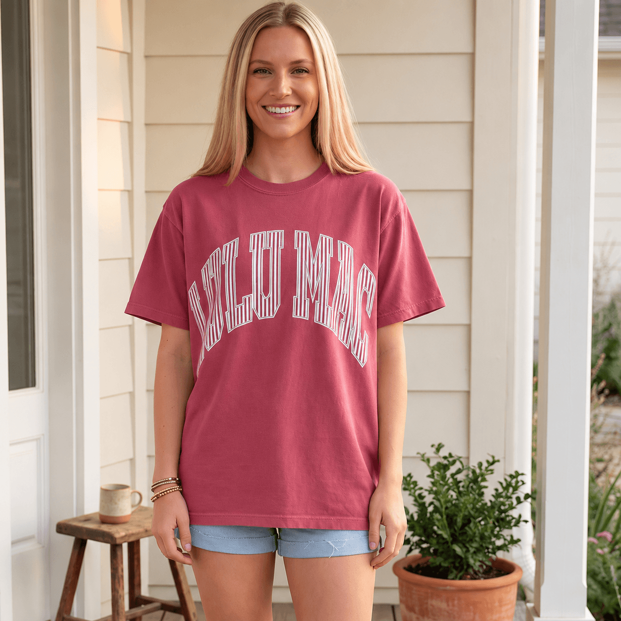 LULU MAC - MINERAL MAROON / STRIPED tee worn by a smiling woman, showcasing a relaxed style in a maroon color.