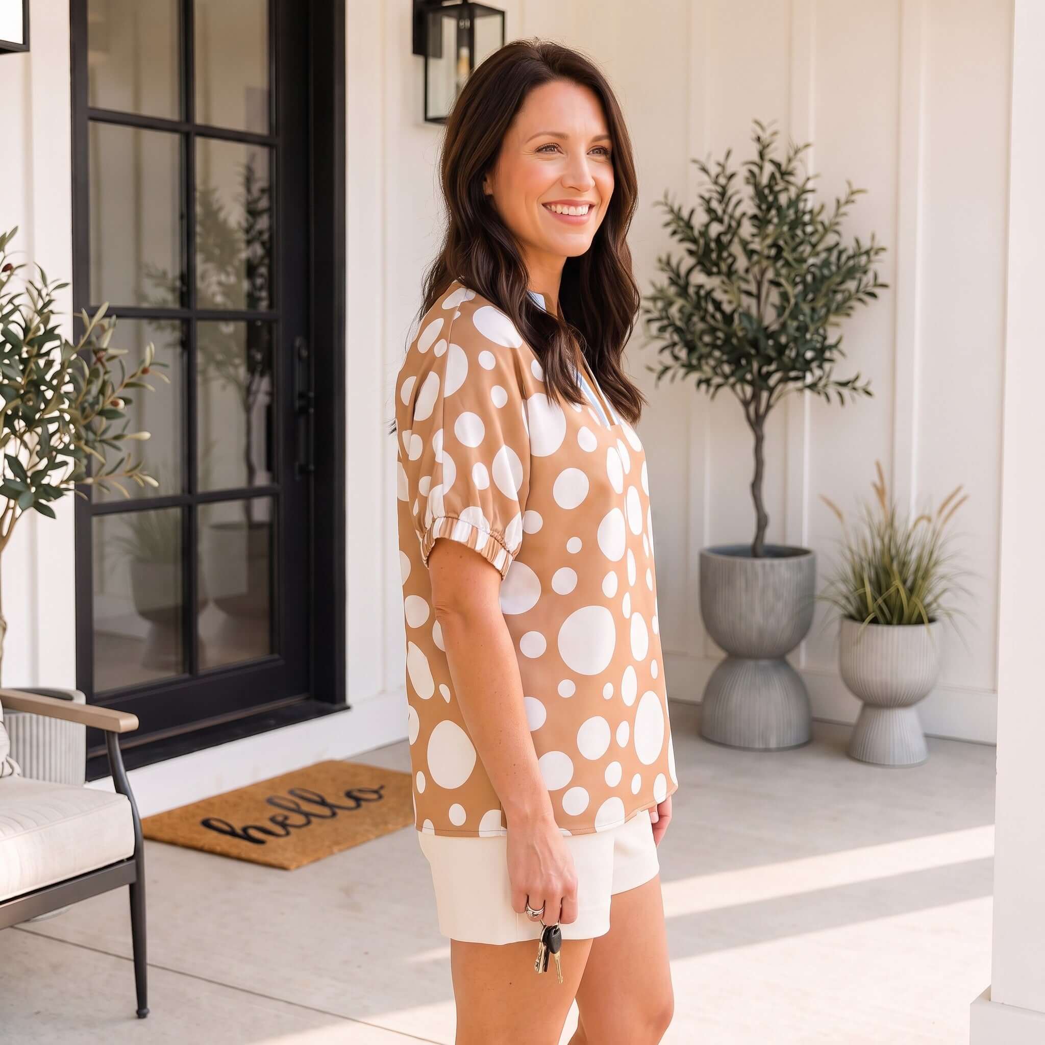 SPOT OF STYLE TOP worn by a woman, showcasing polka dot print in beige and cream, perfect for fall fashion.