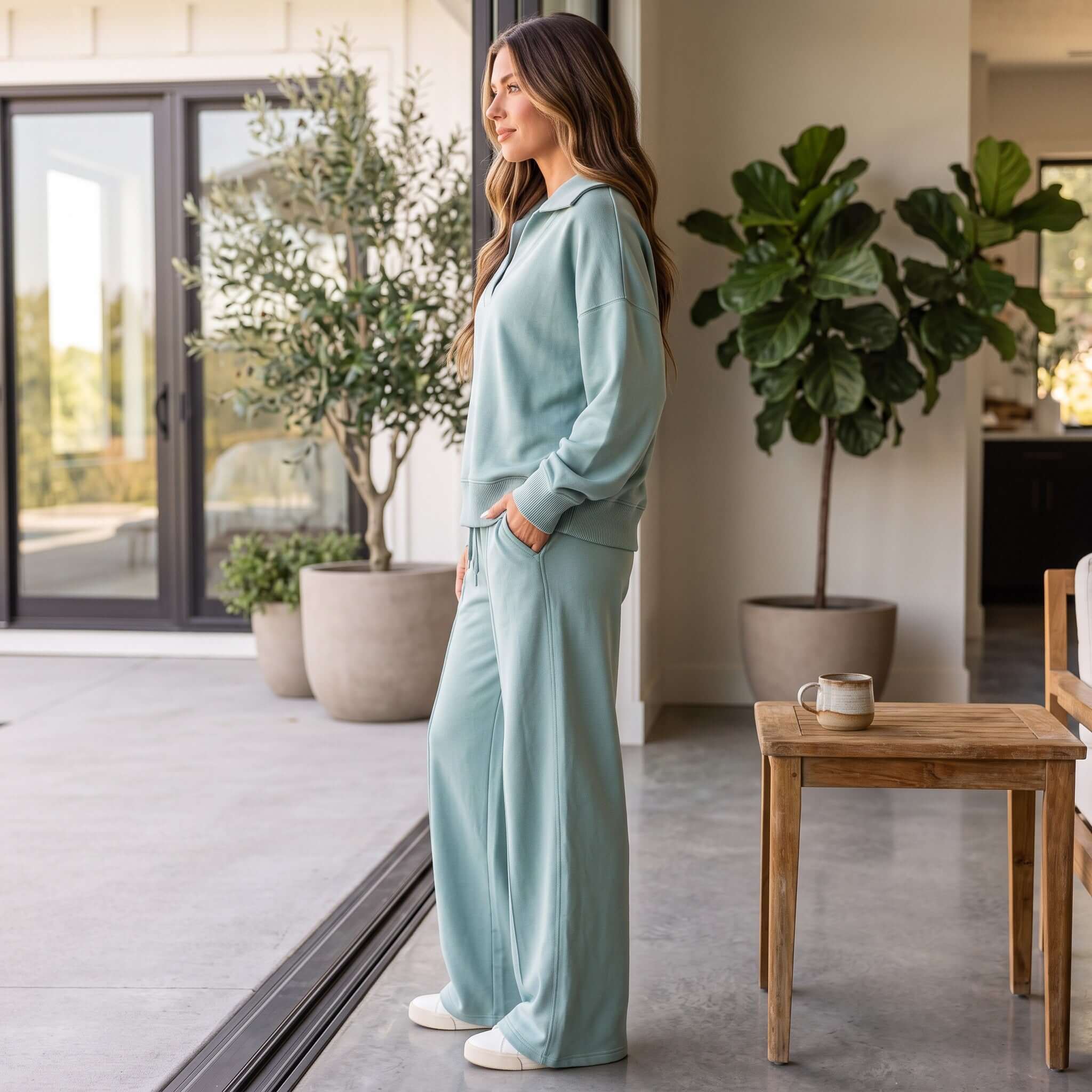 Woman wearing FARMHOUSE FAVE SET (dusty blue) in a modern home setting by Zenana, showcasing relaxed style and comfort.