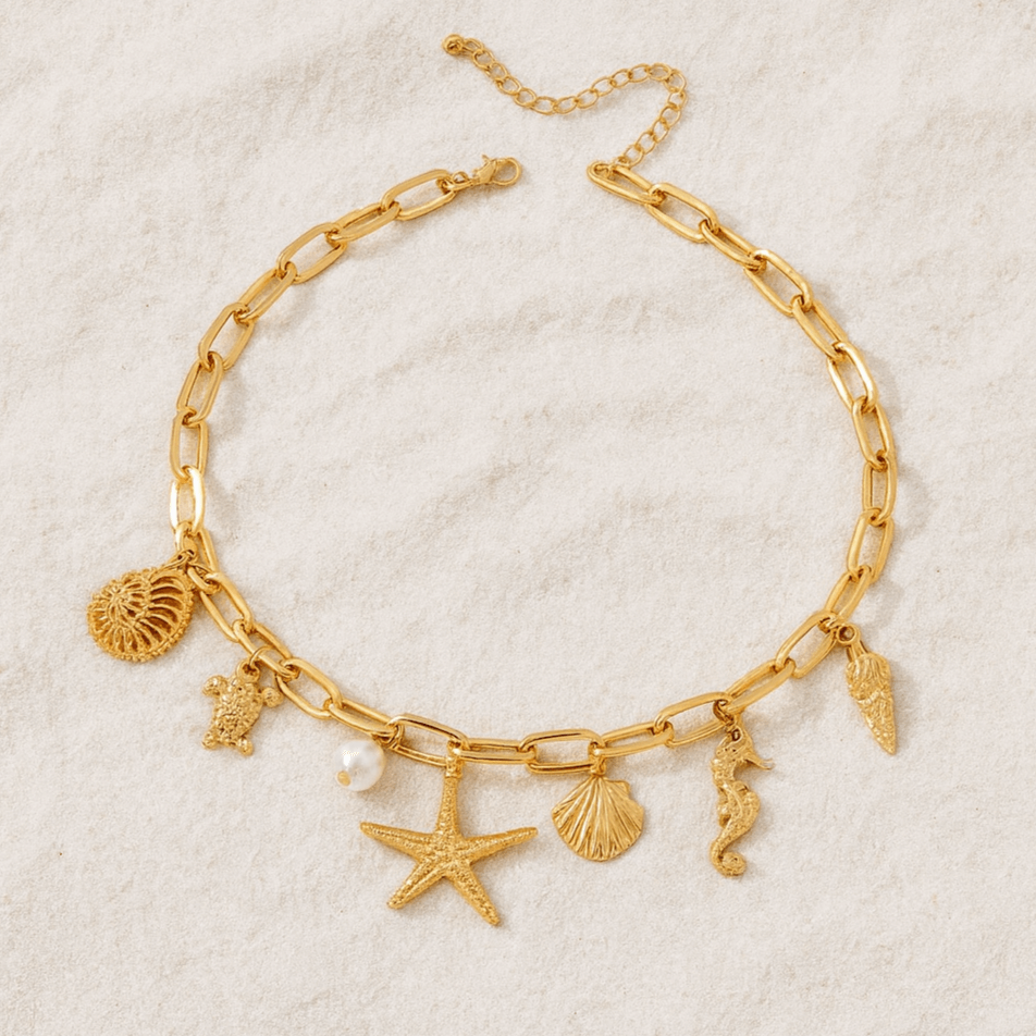 Gold tone charm necklace with starfish, turtle, shell, and seahorse from Coast Keepsakes Collection.