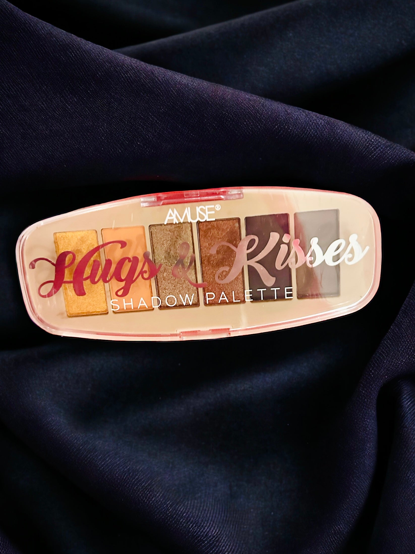 HUGS & KISSES vibrant eyeshadow palette with 6 complementary colors on a dark silk background.
