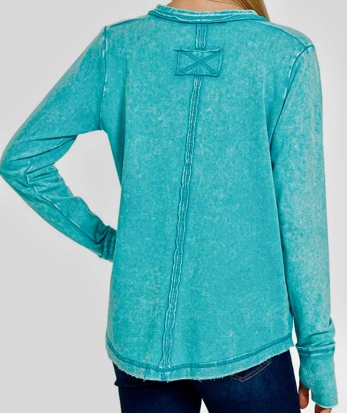 Back view of the Wanderlight Henley Top (teal) showcasing the mineral wash and raw edge details.