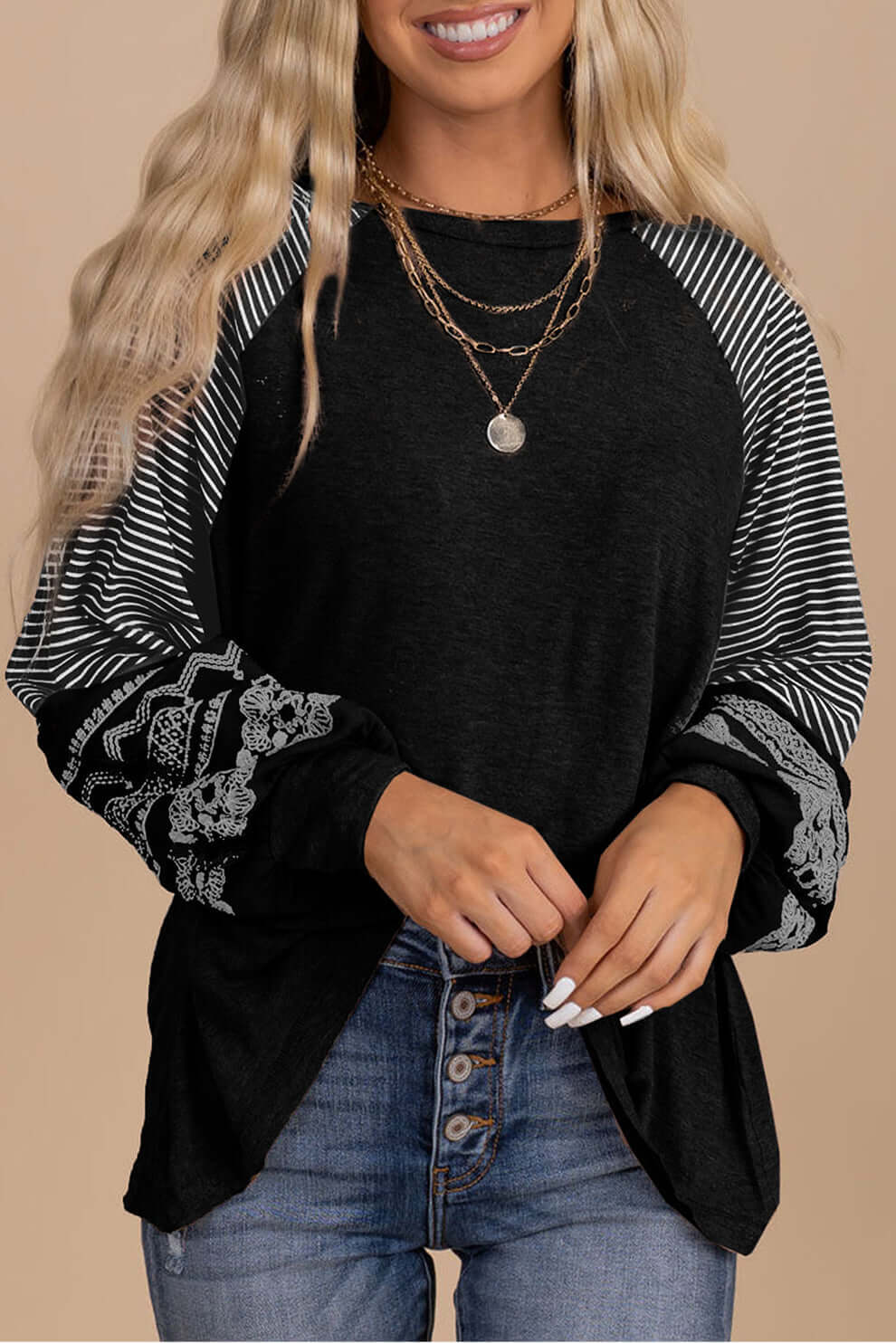 Finding Time (soft black) long sleeve top featuring striped raglan sleeves and playful prints.
