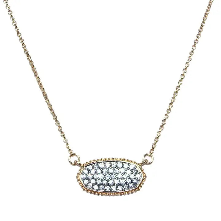 Druzy oval pendant necklace with gold chain, featuring sparkling textured stones in an elegant design.