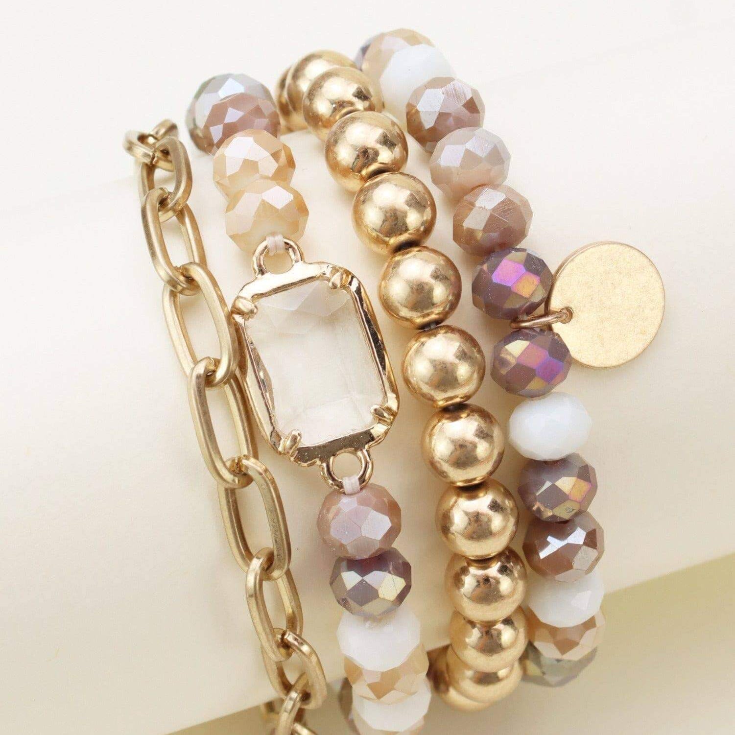 Stylish 4-piece Prism Collection bracelet set with metallic and faceted beads in pastel tones.