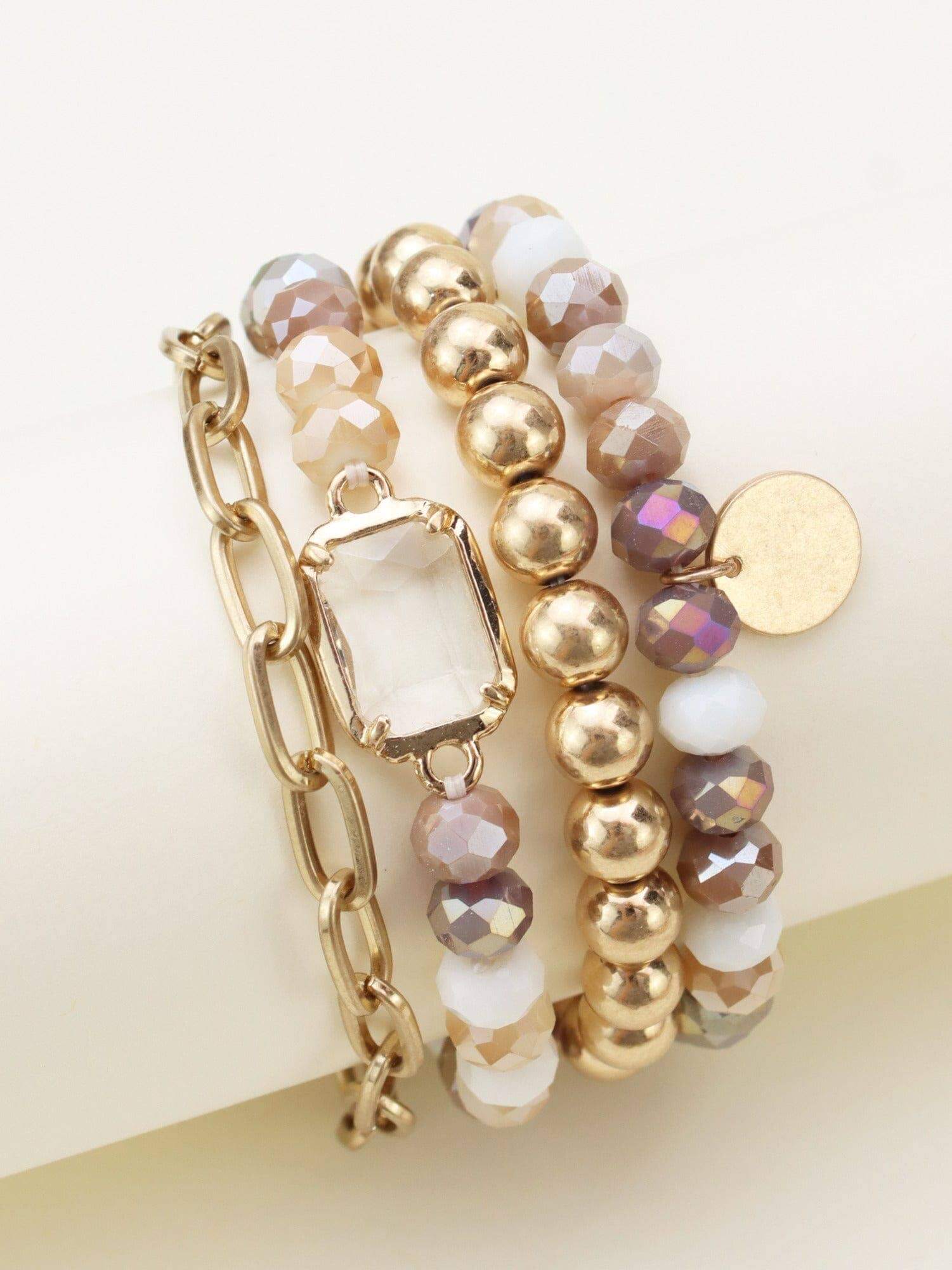 Stylish 4-piece Prism Collection bracelet set with metallic and faceted beads in pastel tones.